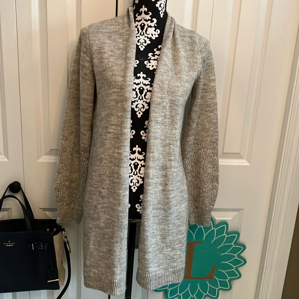 Cozy cream long sweater with open front and great knit detail on arms.